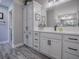 The bright, remodeled main bathroom offers double vanity with quartz countertop, updated faucet, and ample storage at 6295 Danielson Loop, The Villages, FL 32163