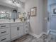 Bright bathroom offers a modern vanity with quartz countertop, updated faucet, and wood-look tile flooring at 6295 Danielson Loop, The Villages, FL 32163