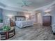 Spacious main bedroom boasts wood-look floors, tray ceilings, and a stylish sitting area for relaxing at 6295 Danielson Loop, The Villages, FL 32163