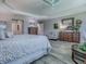 This spacious main bedroom features wood-look floors and detailed decor for a warm ambiance at 6295 Danielson Loop, The Villages, FL 32163