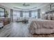 The main bedroom offers a luxurious space, complete with wood-look floors and a cozy sitting area at 6295 Danielson Loop, The Villages, FL 32163
