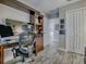 Functional home office showcasing desk space, built-in storage, and a nearby bathroom at 6295 Danielson Loop, The Villages, FL 32163