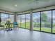 Bright sunroom with floor-to-ceiling windows offering panoramic views of the backyard at 6295 Danielson Loop, The Villages, FL 32163