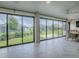 Spacious sunroom with tile flooring and expansive views of the landscaped yard at 6295 Danielson Loop, The Villages, FL 32163