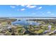 Stunning aerial view of a lake, highlighting the community's parks and waterfront access with boat docks at 6616 Tuscawilla Dr, Leesburg, FL 34748
