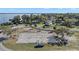 Aerial view features a volleyball court near the water, with the neighborhood beyond at 6616 Tuscawilla Dr, Leesburg, FL 34748