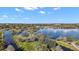 Breathtaking aerial view showcasing lush surroundings and serene lakefront property, ideal for nature enthusiasts at 6616 Tuscawilla Dr, Leesburg, FL 34748