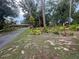Lush landscaping complements this home, framed by mature trees and a well-manicured lawn at 6616 Tuscawilla Dr, Leesburg, FL 34748