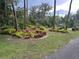 Beautiful landscaping featuring a variety of colorful bromeliads and lush greenery at 6616 Tuscawilla Dr, Leesburg, FL 34748