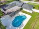 Aerial view of the backyard featuring a private pool with large concrete sundeck and covered outdoor patio at 6829 Bittersweet Ln, Orlando, FL 32819