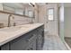 Bathroom featuring double vanity with modern fixtures and patterned floor tiles at 6829 Bittersweet Ln, Orlando, FL 32819