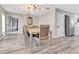 Elegant dining room with wood-look flooring, chandelier, and designer mirror at 6829 Bittersweet Ln, Orlando, FL 32819