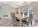 Formal dining room with modern chandelier, wood floors, and a large wooden table at 6829 Bittersweet Ln, Orlando, FL 32819