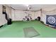 Finished garage with gym equipment and green turf, creating a dedicated workout and recreational space at 6829 Bittersweet Ln, Orlando, FL 32819