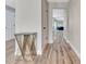Bright hallway with wood-look floors, neutral paint and decorative table at 6829 Bittersweet Ln, Orlando, FL 32819