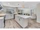 A modern, sleek kitchen with stainless steel appliances, white cabinets, and a spacious island at 6829 Bittersweet Ln, Orlando, FL 32819