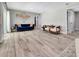 Open-plan living room featuring hardwood floors, and a comfortable royal blue couch at 6829 Bittersweet Ln, Orlando, FL 32819