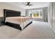 The main bedroom offers an abundance of natural light, closet space, and plush carpeting at 6829 Bittersweet Ln, Orlando, FL 32819