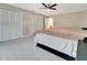 Spacious main bedroom featuring a ceiling fan, carpeted floors and access to a private bathroom at 6829 Bittersweet Ln, Orlando, FL 32819