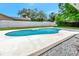Inviting in-ground pool surrounded by a white fence and a well-maintained backyard with lush green grass at 6829 Bittersweet Ln, Orlando, FL 32819