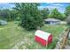 Aerial view of a charming home and property with outbuilding and swimming pool at 8634 Garden Way Rd, Groveland, FL 34736