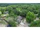 Aerial view of home and surrounding landscape of mature trees and outbuildings at 8634 Garden Way Rd, Groveland, FL 34736