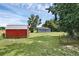 Large backyard featuring a shed with ample green space at 8634 Garden Way Rd, Groveland, FL 34736