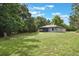 Expansive backyard featuring green lawn and screened in porch perfect for outdoor entertaining at 8634 Garden Way Rd, Groveland, FL 34736