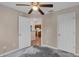 Bedroom with ceiling fan, concrete floors, and a view into the kitchen at 8634 Garden Way Rd, Groveland, FL 34736