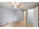 Neutral bedroom features a ceiling fan and a closet at 8634 Garden Way Rd, Groveland, FL 34736