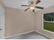 Bedroom with a window, ceiling fan, neutral walls, and concrete floors at 8634 Garden Way Rd, Groveland, FL 34736