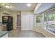 Open-concept breakfast nook featuring tiled floors, bay windows, and ample space at 8634 Garden Way Rd, Groveland, FL 34736
