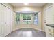 Sunlit breakfast nook with tiled floors, bay windows, and a closet for extra storage at 8634 Garden Way Rd, Groveland, FL 34736
