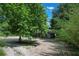Peaceful home exterior framed by mature trees providing shade and privacy at 8634 Garden Way Rd, Groveland, FL 34736
