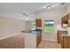 Kitchen area featuring breakfast bar, upper cabinets and backyard views at 8634 Garden Way Rd, Groveland, FL 34736