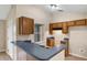 Bright kitchen featuring wood cabinets, breakfast bar, and tile flooring at 8634 Garden Way Rd, Groveland, FL 34736