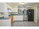 Spacious kitchen with white cabinets, stainless steel appliances, and a view to the living space at 8634 Garden Way Rd, Groveland, FL 34736