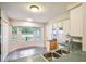 Bright kitchen with tiled floors, stainless steel sink, and a breakfast nook with bay windows at 8634 Garden Way Rd, Groveland, FL 34736