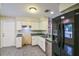 Well-lit kitchen featuring white cabinets, stainless steel appliances, and tiled floors at 8634 Garden Way Rd, Groveland, FL 34736