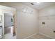 Spacious laundry room with tile floors and access to the bedroom and outside at 8634 Garden Way Rd, Groveland, FL 34736