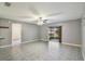 Bright living room with a ceiling fan, tiled floors, and access to the screened patio at 8634 Garden Way Rd, Groveland, FL 34736