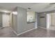 Cozy living room featuring gray walls, tiled floors, and a breakfast bar viewing the kitchen at 8634 Garden Way Rd, Groveland, FL 34736