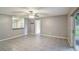 Open living room featuring gray tile flooring and a ceiling fan at 8634 Garden Way Rd, Groveland, FL 34736