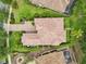 Bird's-eye view of property featuring a tile roof, lush landscaping, and well-maintained grounds at 9433 San Miguel, Howey In The Hills, FL 34737