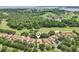 Aerial view of beautiful home near lush golf course and serene lake at 9433 San Miguel, Howey In The Hills, FL 34737