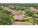 Aerial view of the neighborhood showcases tile roofs, lush landscaping, and well-maintained homes at 9433 San Miguel, Howey In The Hills, FL 34737
