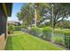 Spacious backyard with lush lawn, wrought iron fence, and view of the picturesque golf course at 9433 San Miguel, Howey In The Hills, FL 34737