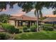 Beautiful backyard featuring lush lawn, mature landscaping, and view of golf course beyond at 9433 San Miguel, Howey In The Hills, FL 34737