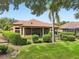 Beautiful backyard features a screened lanai, well-manicured lawn, and lush landscaping, creating a private outdoor oasis at 9433 San Miguel, Howey In The Hills, FL 34737