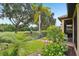 Landscaped backyard with golf course view, featuring a beautiful garden and wrought iron fence at 9433 San Miguel, Howey In The Hills, FL 34737
